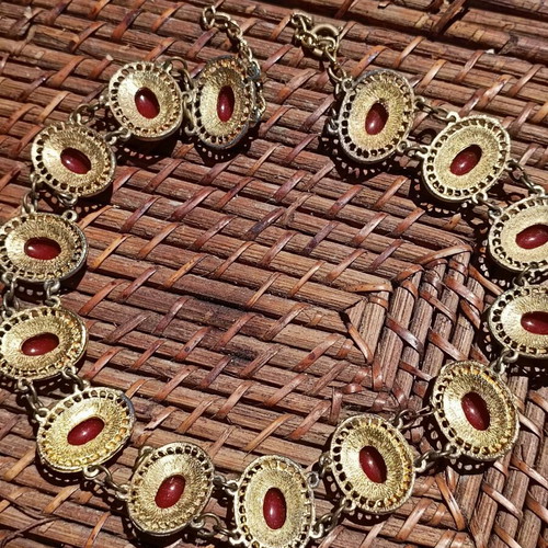 Vintage necklace used with red stones and brass metal