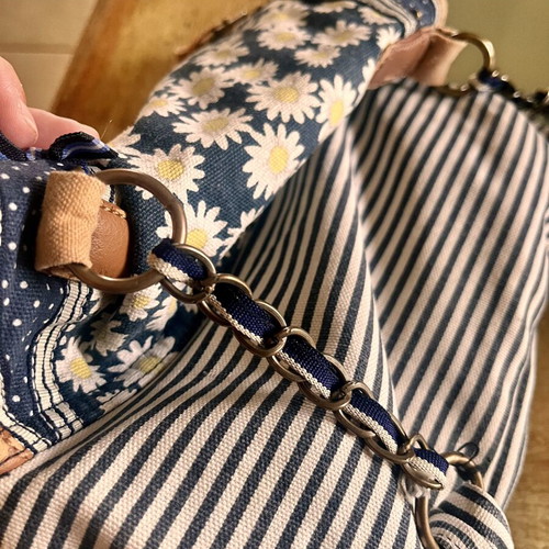 Accessorize vintage crossbody bag with daisies and cherries