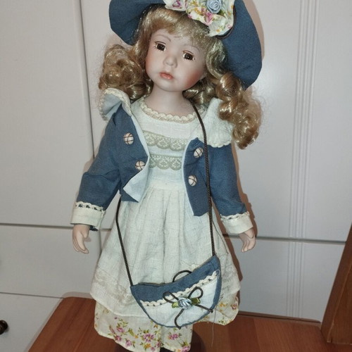 Porcelain doll rare, new with hat and dress