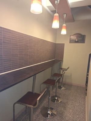 Wall-mounted bar set like new with stools and wooden surface