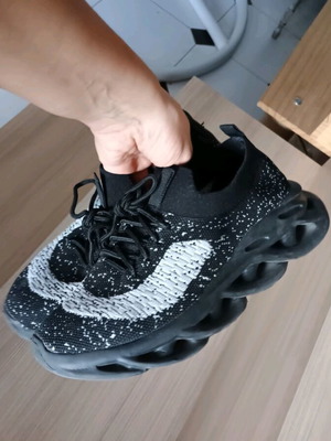 Black knitted athletic shoe with white speckles like new