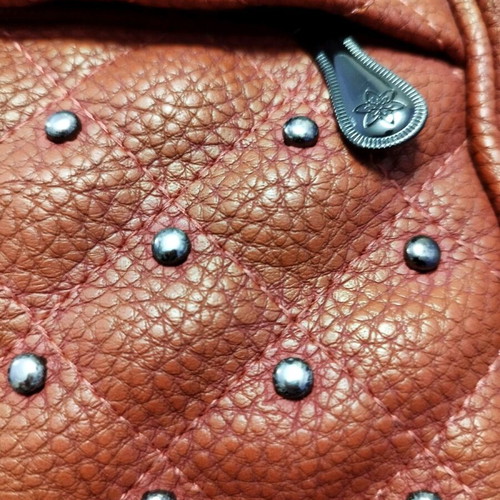 Backpack used red bag with quilted front zipper
