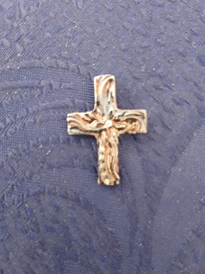 Silver cross with embossed flower design and synthetic yellow zircon stones