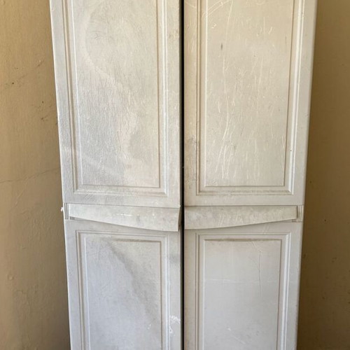 Keter plastic outdoor storage cabinet used, tall and functional