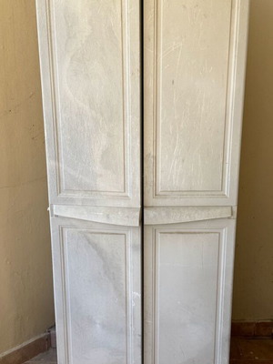 Keter plastic outdoor storage cabinet used, tall and functional