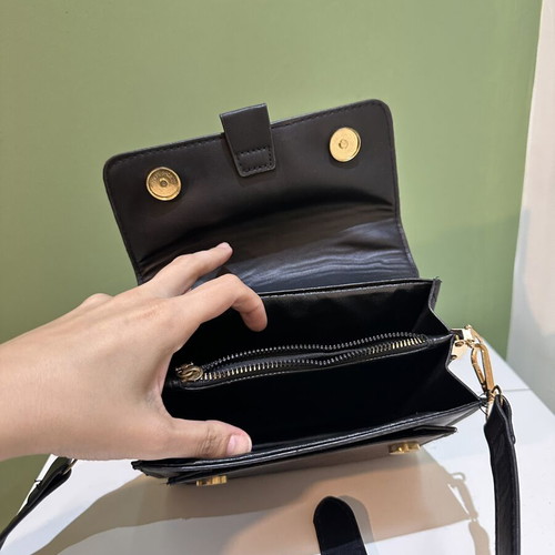Black women's crossbody shoulder bag with gold details