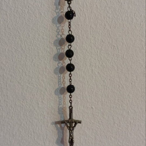 Traditional rosary used, black beads and silver elements