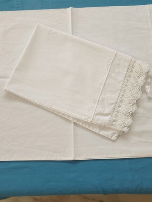 Vintage pair of handmade pillowcases with wide lace and cords, like new