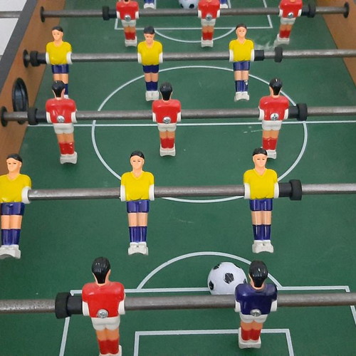 Wooden tabletop foosball used with wooden handles and 2 balls