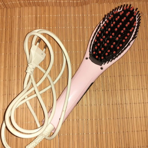 Electric hair straightening brush used