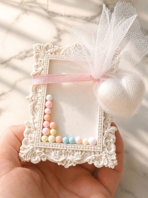 Vintage plaster frame with perfume bottle