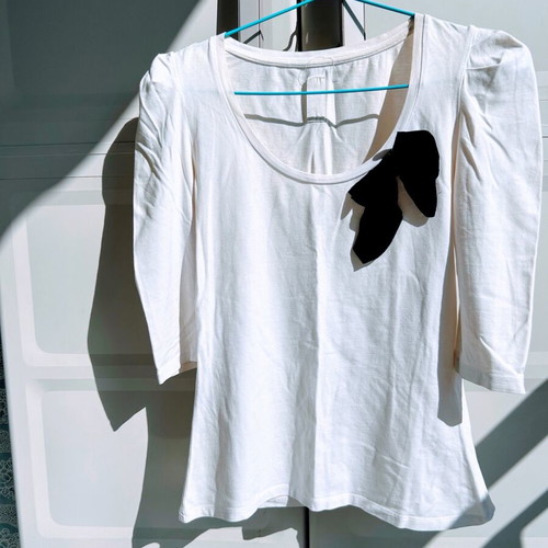 Blouse with black bow and padded sleeves used, size M