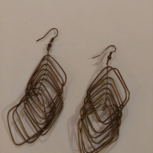 Dangling earrings used, brown and gold color