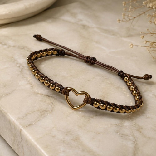 Handmade bracelet with gold beads and steel heart