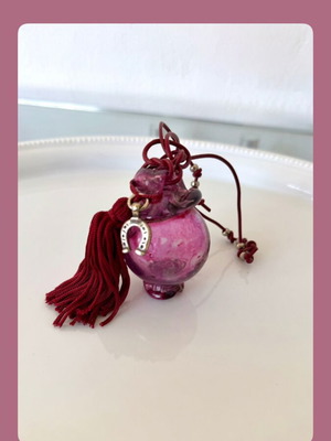 Handmade glass charm in burgundy shades with horseshoe and silk tassel