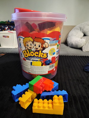Bucket with colorful baby building blocks used