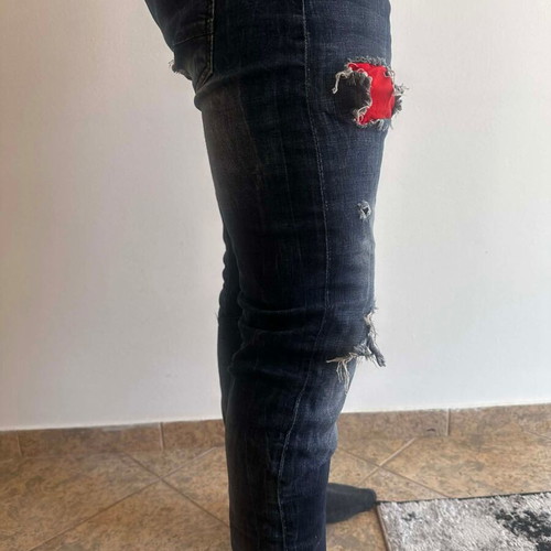 Damaged Jeans pants used with rips, blue and red