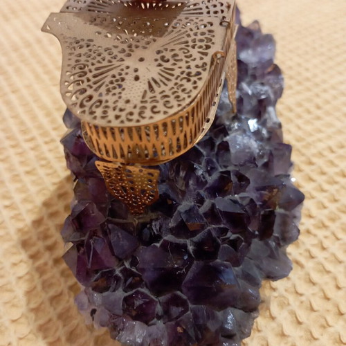 Vintage decorative piano on natural amethyst rock, gold-plated