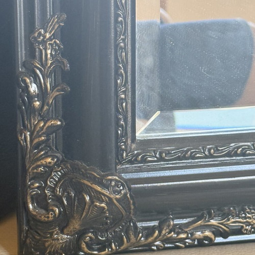 Woodcarved mirror with brass details used