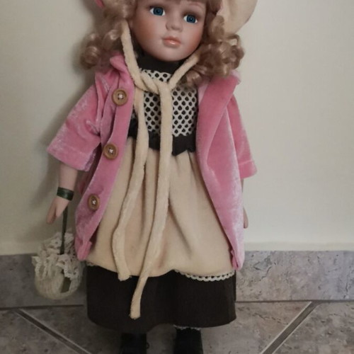 Collectible doll with coat and handbag like new