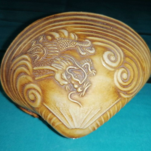 Vintage carved shell with dragon and scenic details