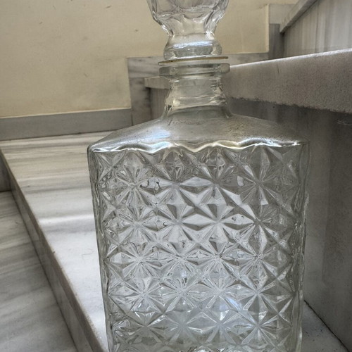 Glass liquor bottle used with embossed design