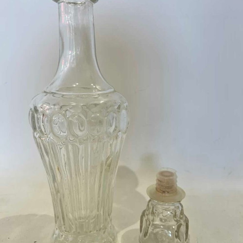 Vintage glass carafe with embossed designs used