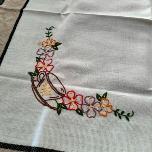 Embroidered square table linen with coffee cup and floral design