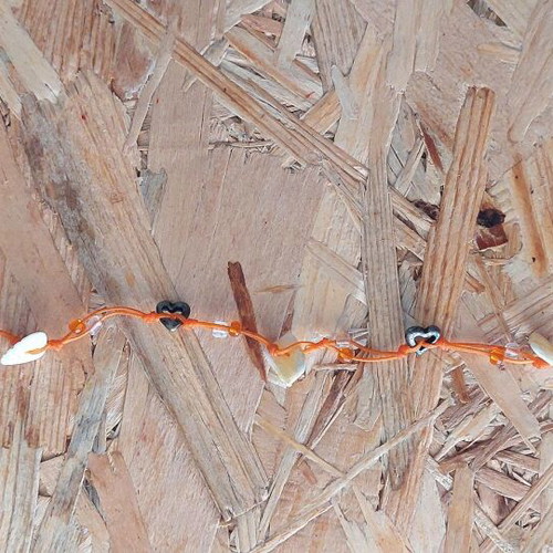 Handmade orange anklet with shells and metal hearts