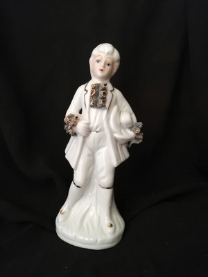 Porcelain figure used, approximately 16 cm tall