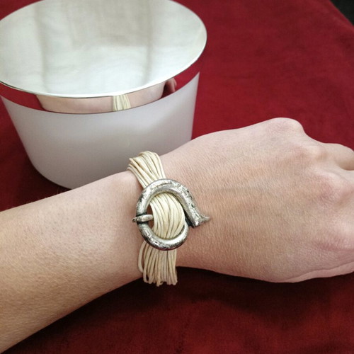 Bracelet with beige cords and metal elements like new