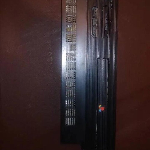 PlayStation 2 fat console with two games