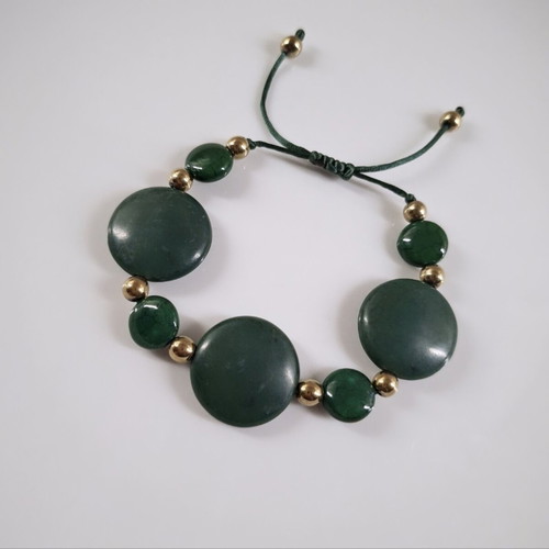 Bracelet with green stones and gold details, adjustable cord