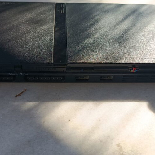 Sony PlayStation 2 slim console with 5 games, power supply and cables