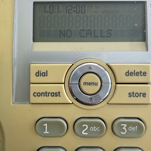 Corded phone with speakerphone used, white