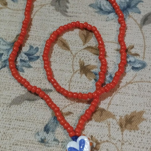 Handmade necklace with beads in summer orange color and murano heart pendant