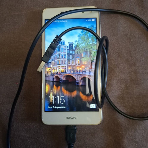Huawei mobile phone used, white, with headphones and charger
