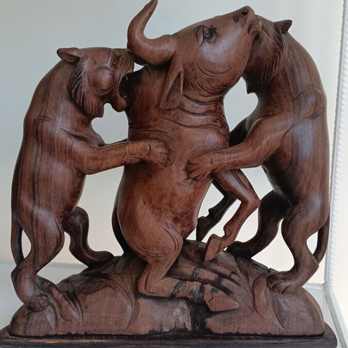 Hunting scene with buffalo and predators wood carving