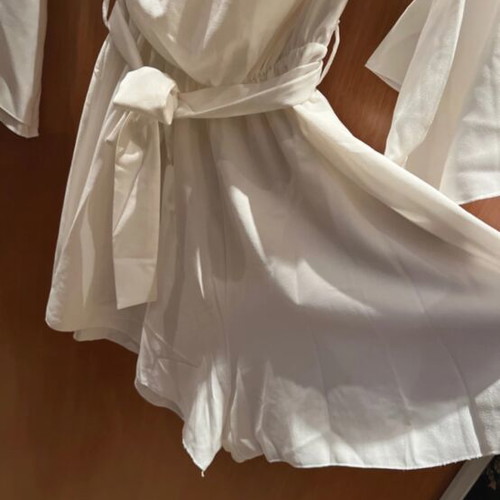 White mini shorts romper with loose sleeves and waist belt