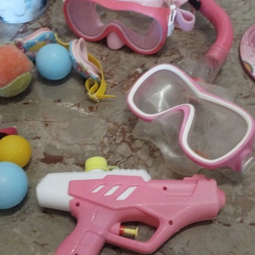 Beach items used, pack with masks, rackets, balls, bucket, sunglasses