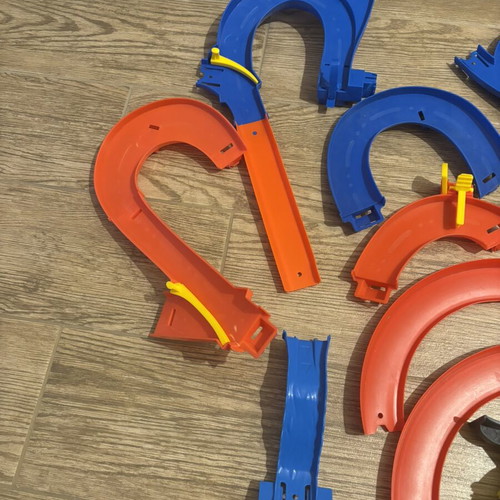 Hot Wheels track set pieces with T-Rex figure and launcher