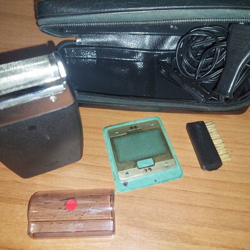Electric shaver used with case, power cord, cleaning brush, and replacement foil
