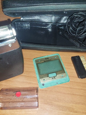 Electric shaver used with case, power cord, cleaning brush, and replacement foil