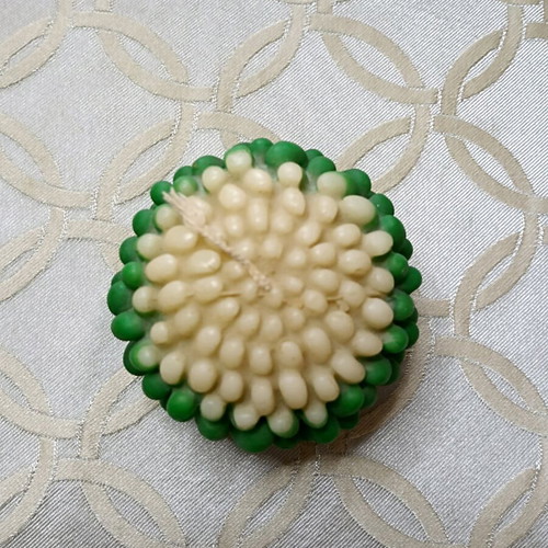 Green and ecru flower-shaped candle new