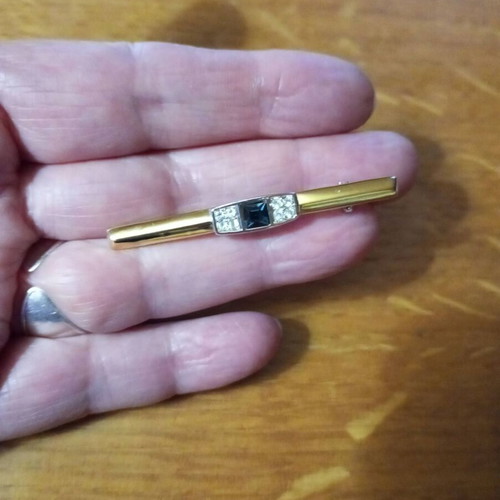 Jewelry pin like new, gold color with blue and clear stones