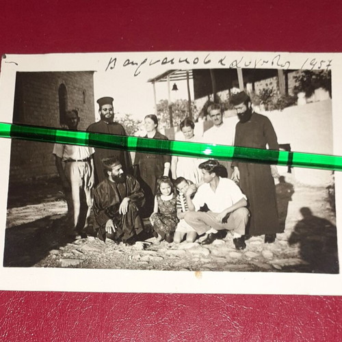 Old black and white photo 1957 with family and priests