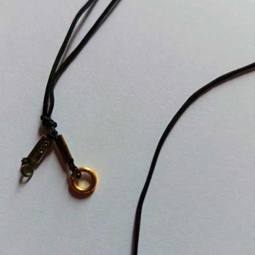 Necklace with gold charm used, black cord