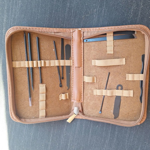 Skin and nail care tools set in small brown case