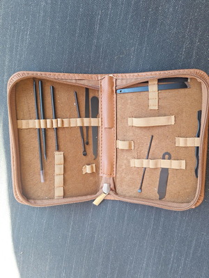 Skin and nail care tools set in small brown case