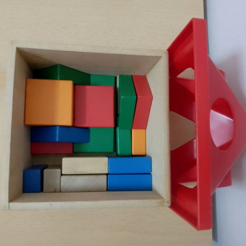 Wooden toys used with house, boat, and shapes